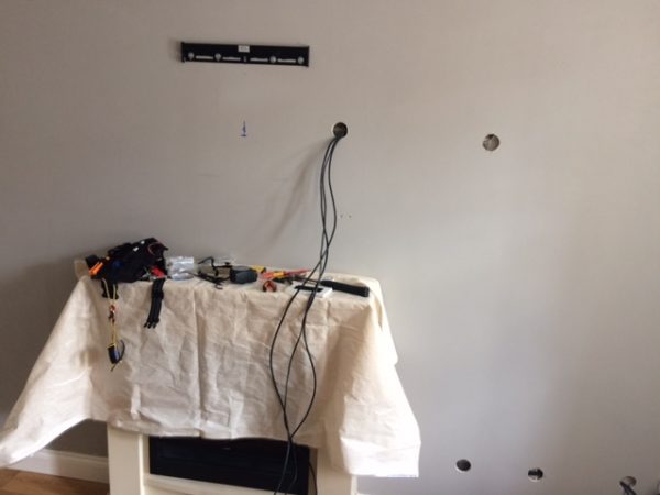 Tv installation - getting around obstacles within the cavity. Hence the locations of the holes in the wall.